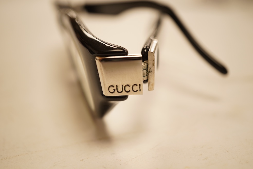 Two pairs of vintage Cartier gilt metal glasses, a pair of Gucci glasses and another